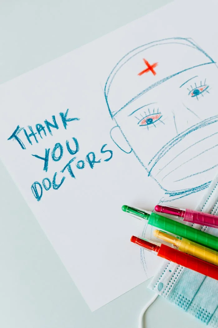 Colorful drawing thanking doctors with pencils and face mask.